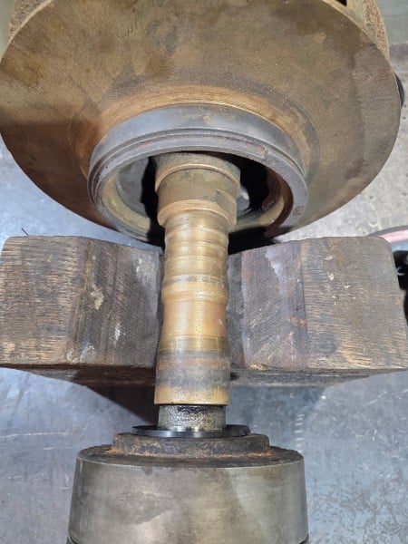Close-up of a metal skateboard truck showing the baseplate, kingpin, and bushings assembly